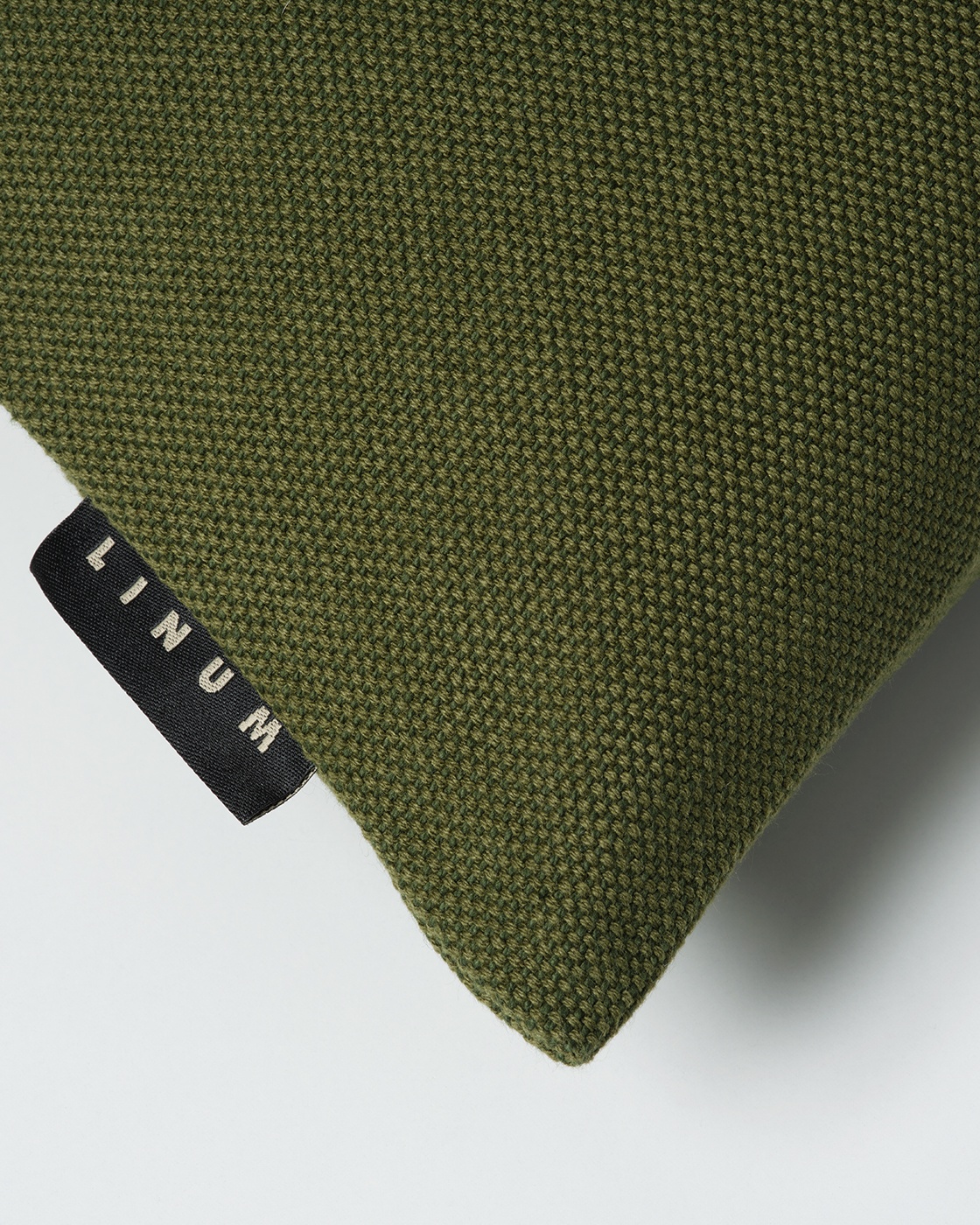 Product image dark olive green PEPPER cushion cover made of soft cotton from LINUM DESIGN. Easy to wash and durable for generations. Size 40x40 cm.