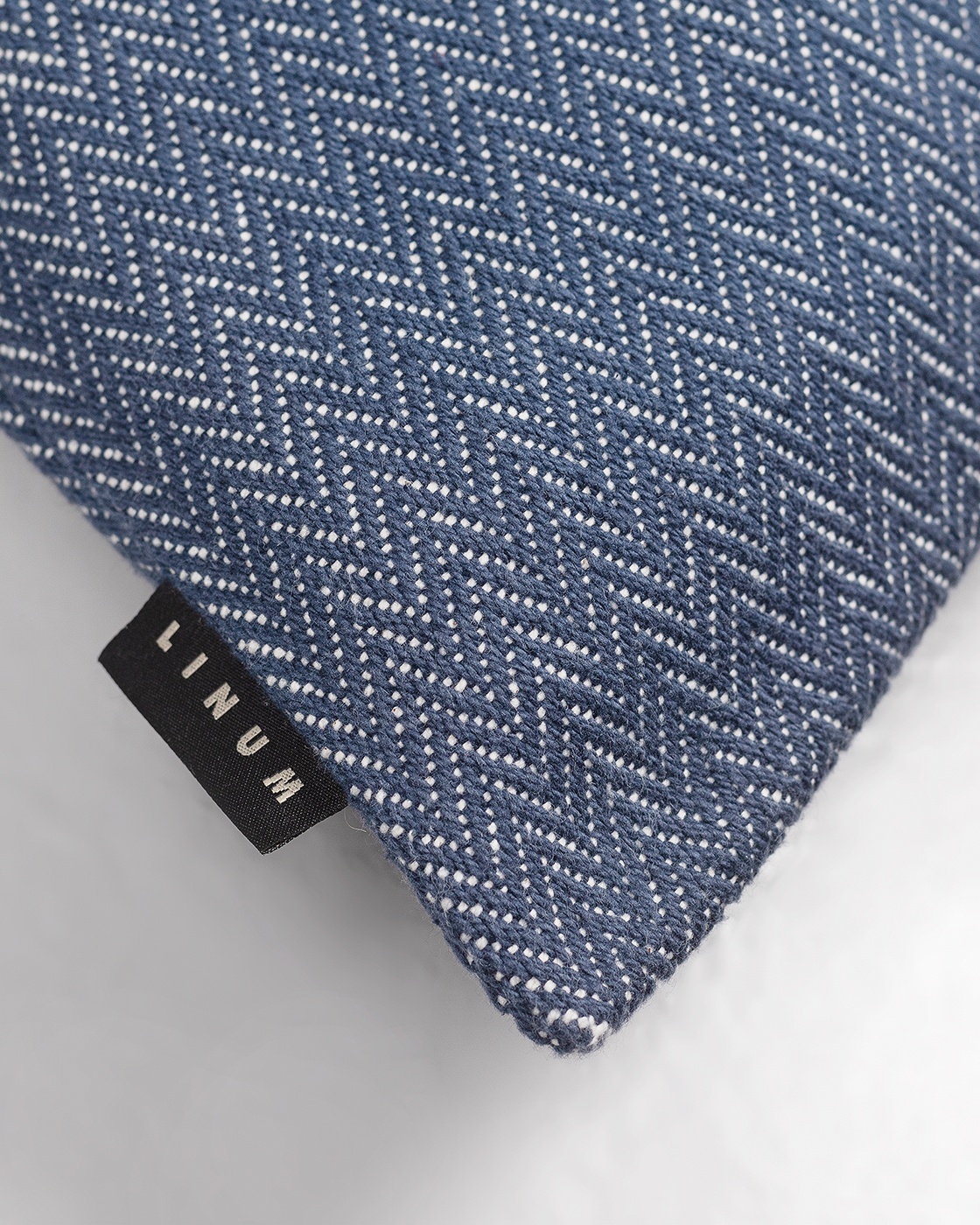 Product image ink blue SHEPARD cushion cover made of soft cotton with a discreet herringbone pattern from LINUM DESIGN. Size 50x50 cm.